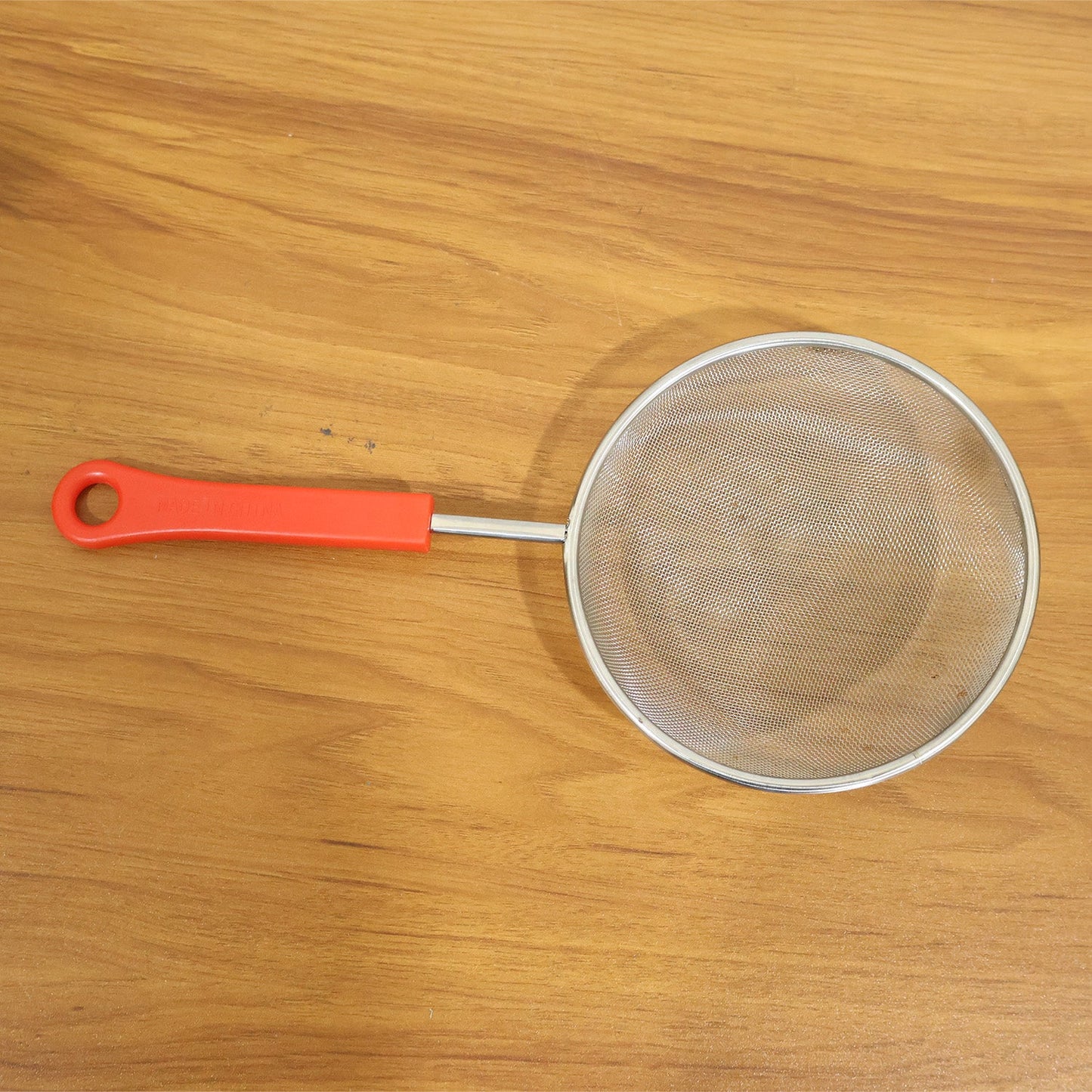 Kitchen strainer in use during cooking and food preparation
