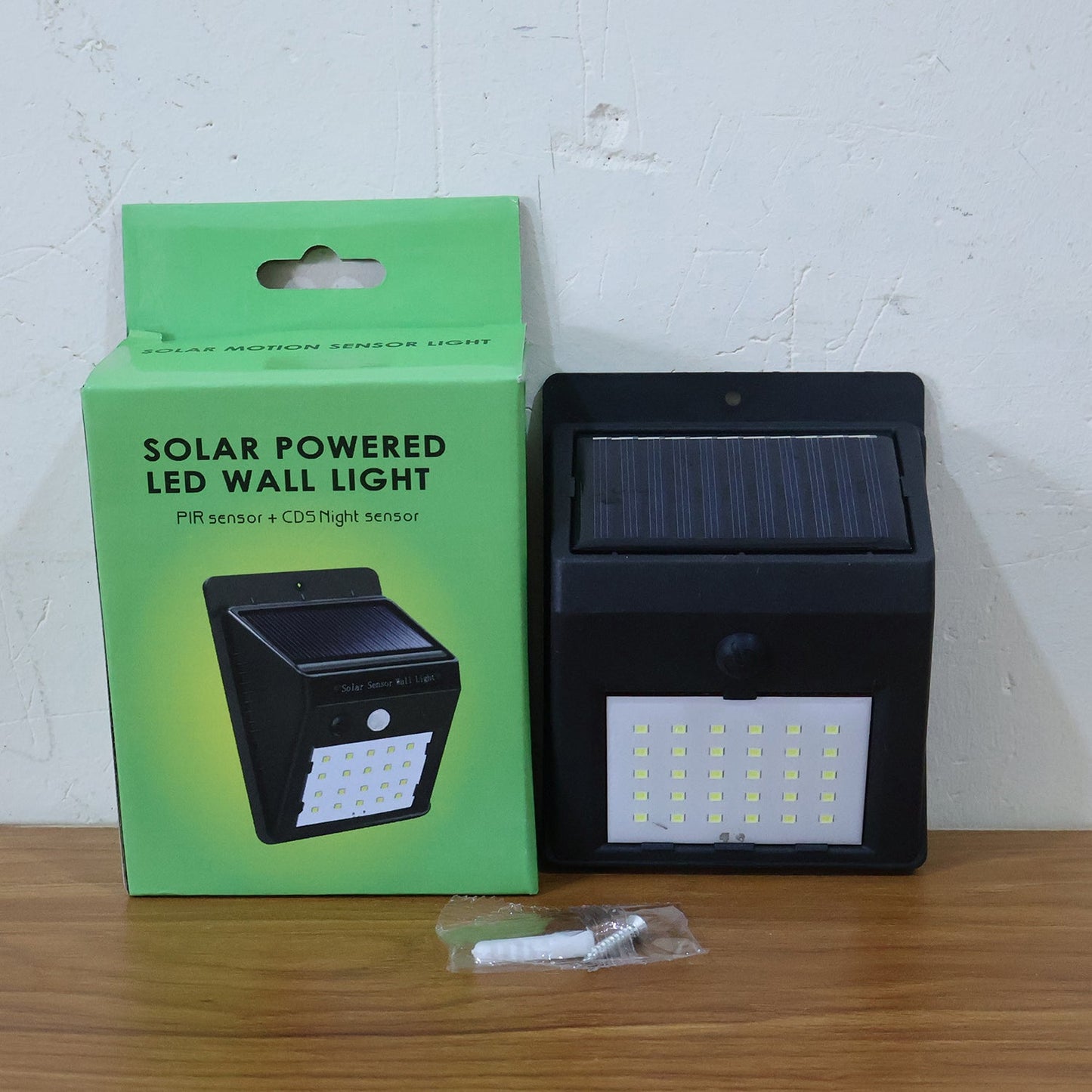 Comparison shot of solar powered LED wall light on outdoor wall