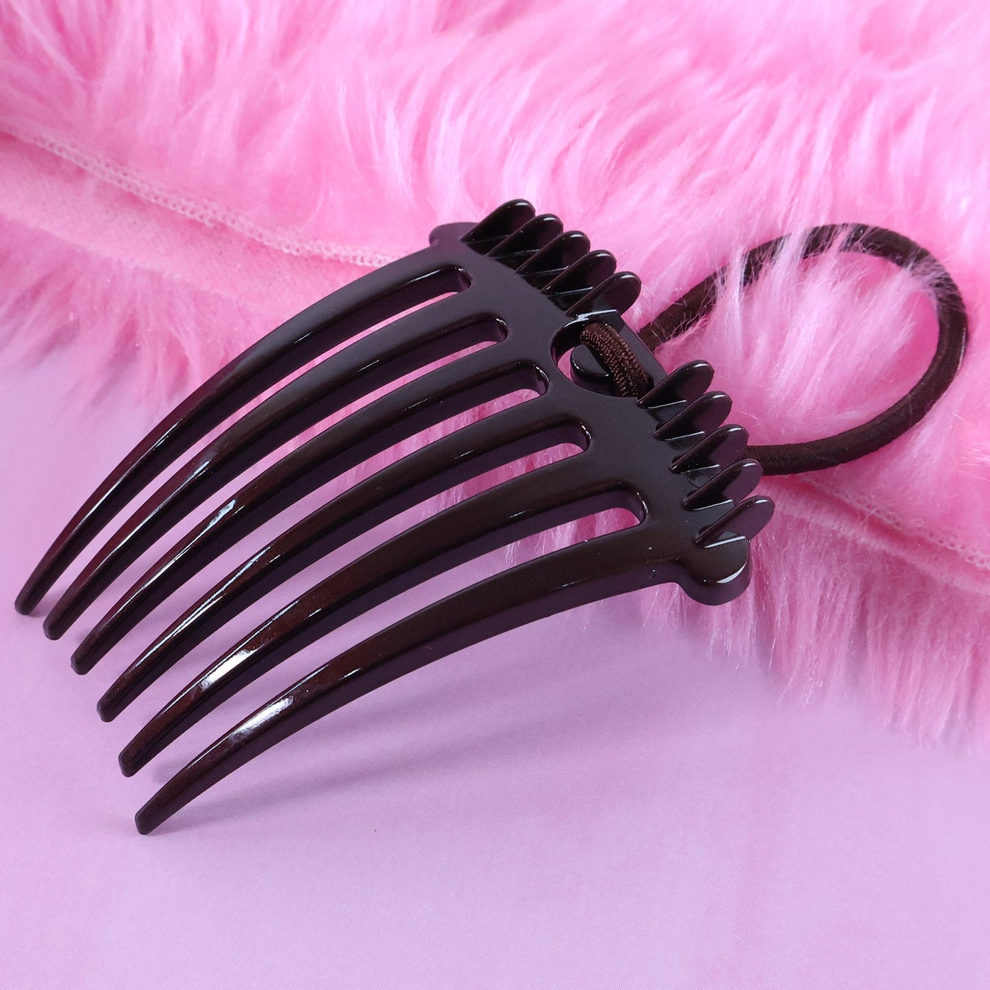 Detailed side profile of the Ponytail Comb, highlighting its robust construction and elastic.