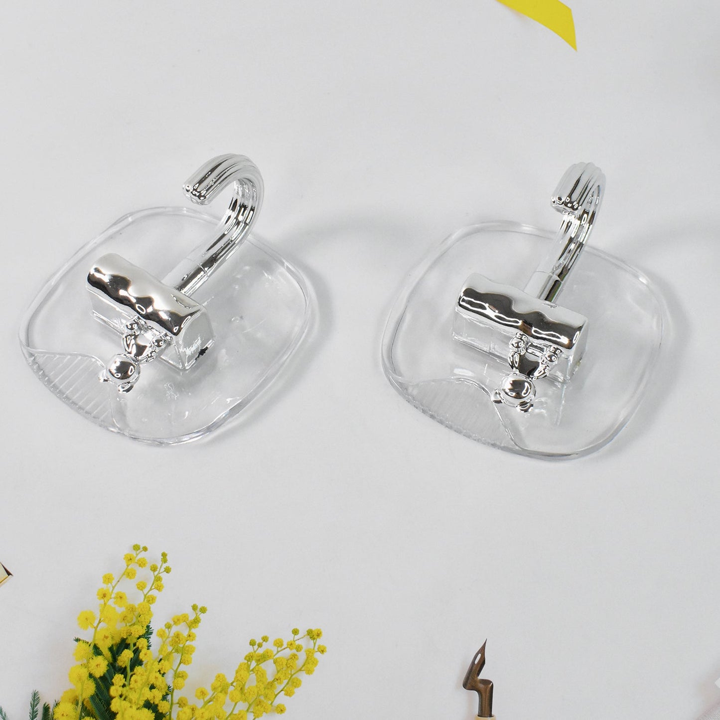 Strong plastic self adhesive wall hooks fixed on kitchen backsplash