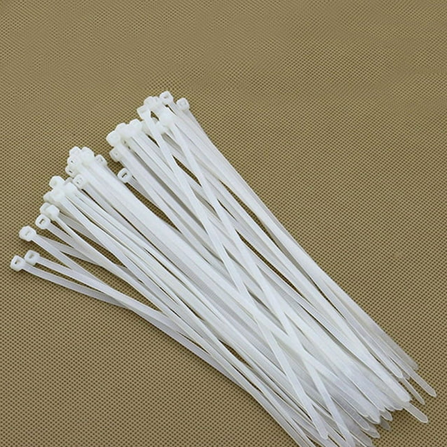 Flexible heavy-duty nylon cable ties being used to secure items outdoors.