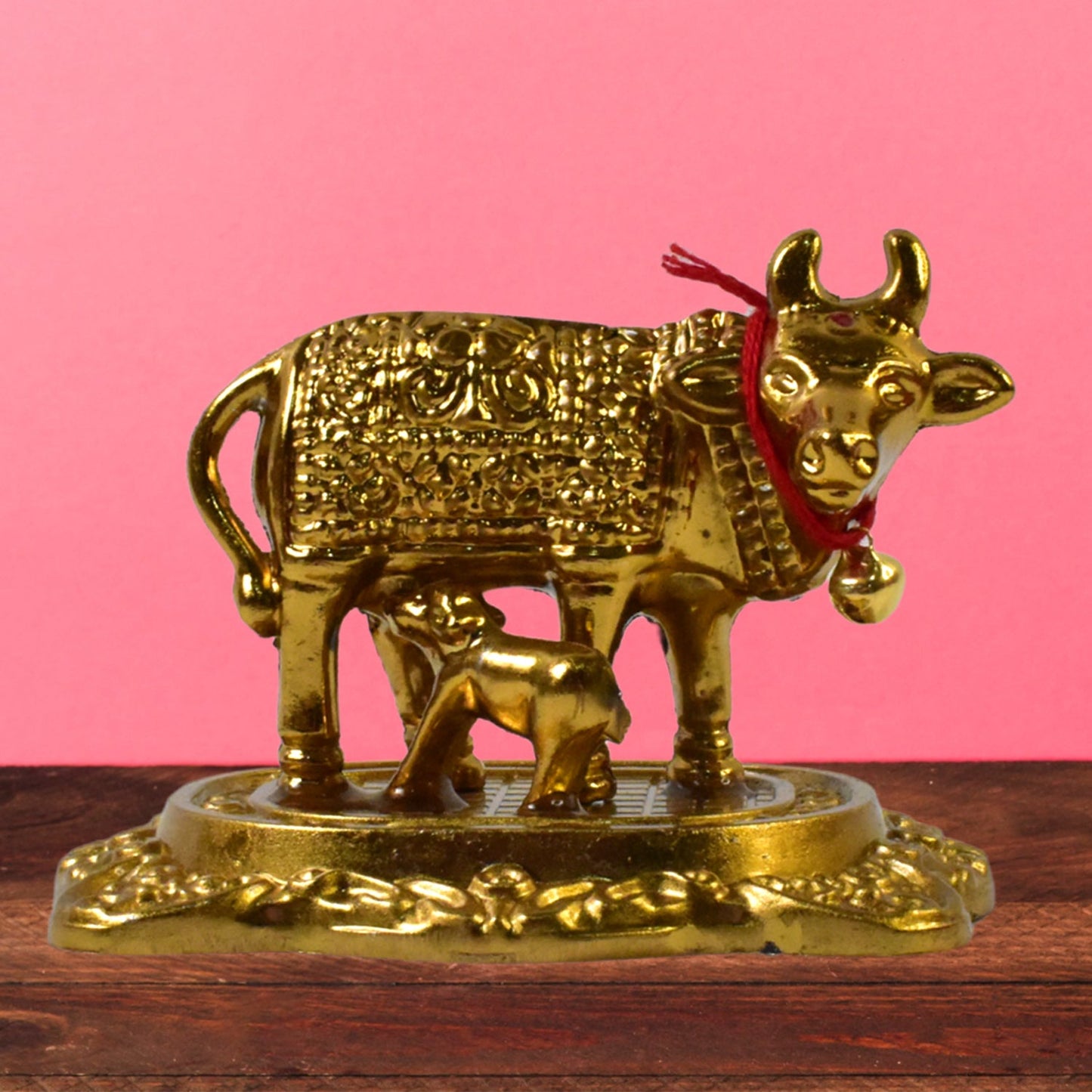 Sacred metal Kamdhenu Cow and calf idol in golden finish