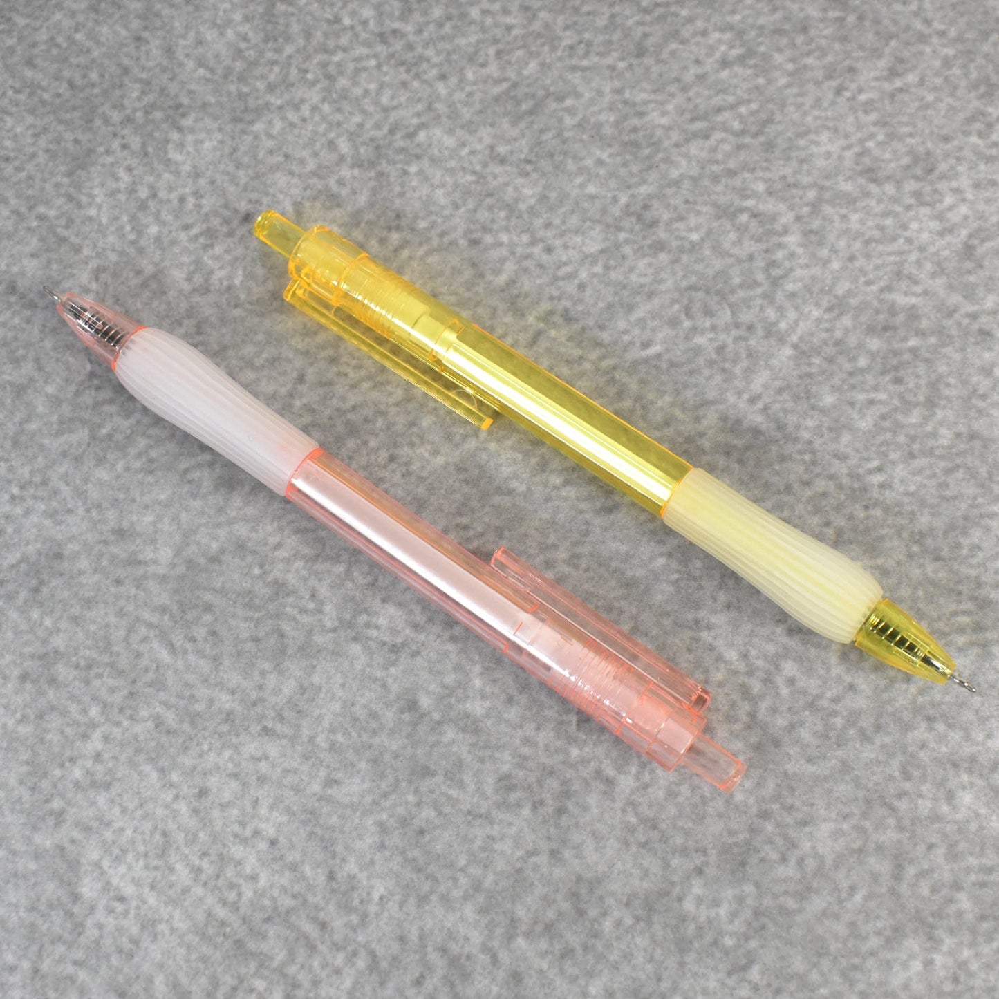 A pair of CustoPen ballpoint pens displayed with essential office stationery.