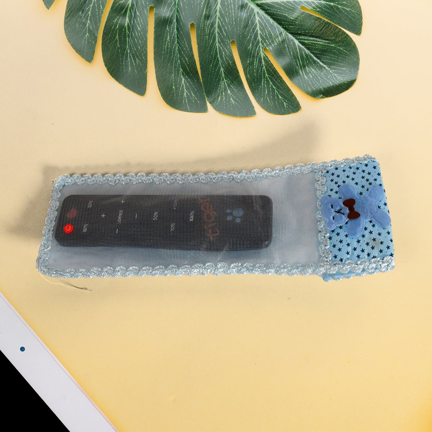 Cute cartoon-themed remote cover in a vibrant cloth design.