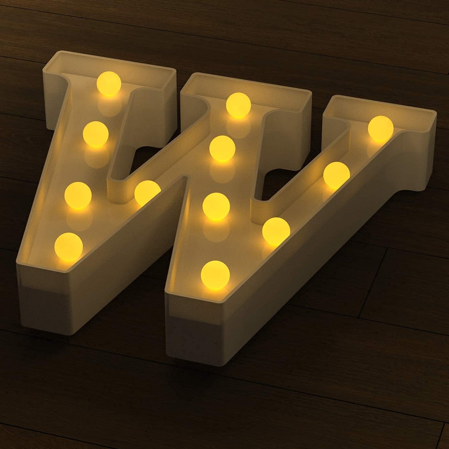 Decorative LED night light shaped as letter W showcasing warm light