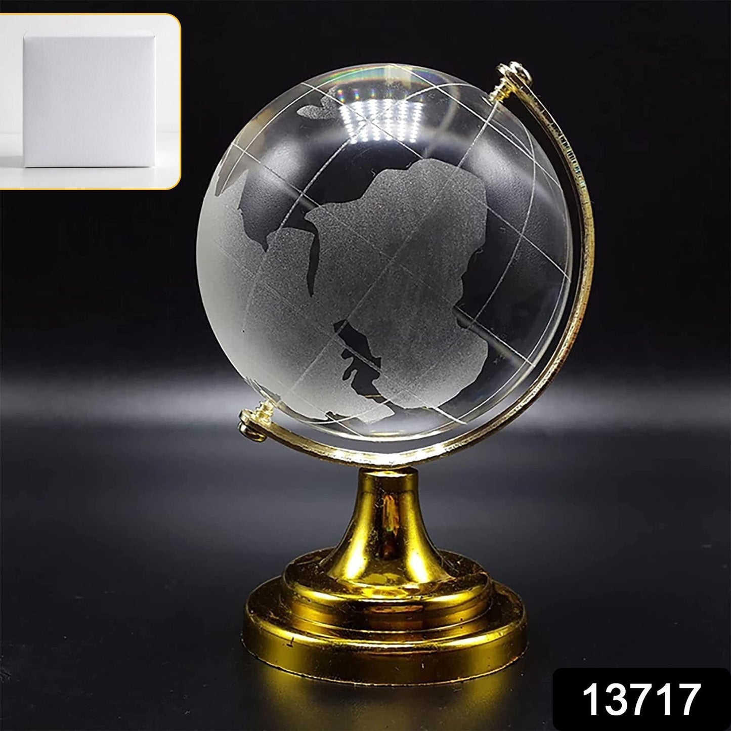 Close-up of a Crystal World Globe showing detailed world map etching on a golden stand.