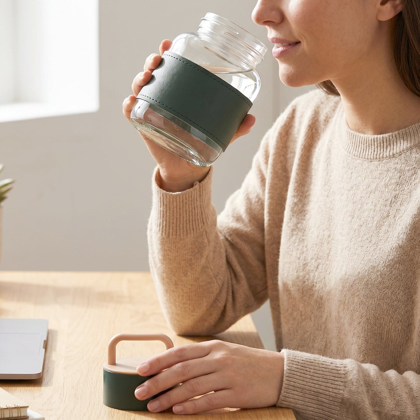 Glass bottle being used for drinking water at home or office