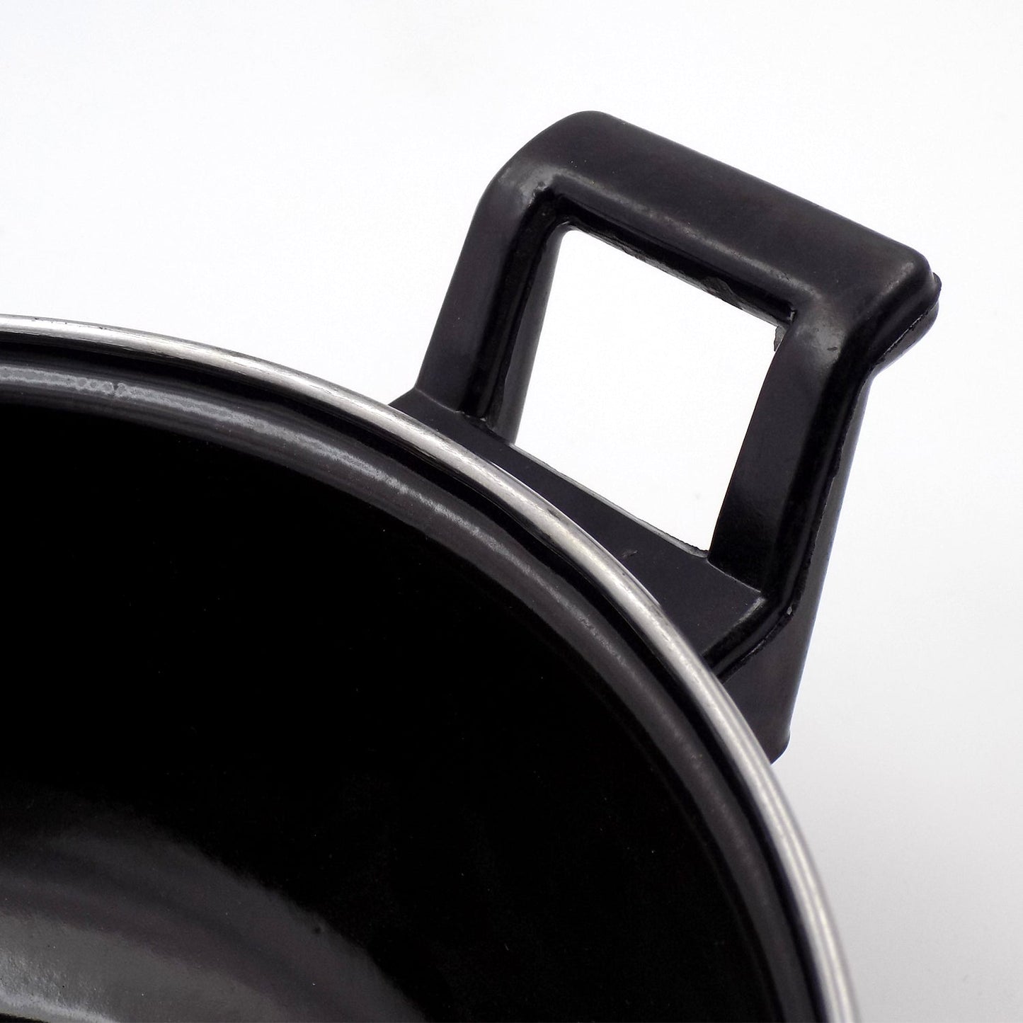 Close-up view of cast iron kadai surface highlighting seasoning