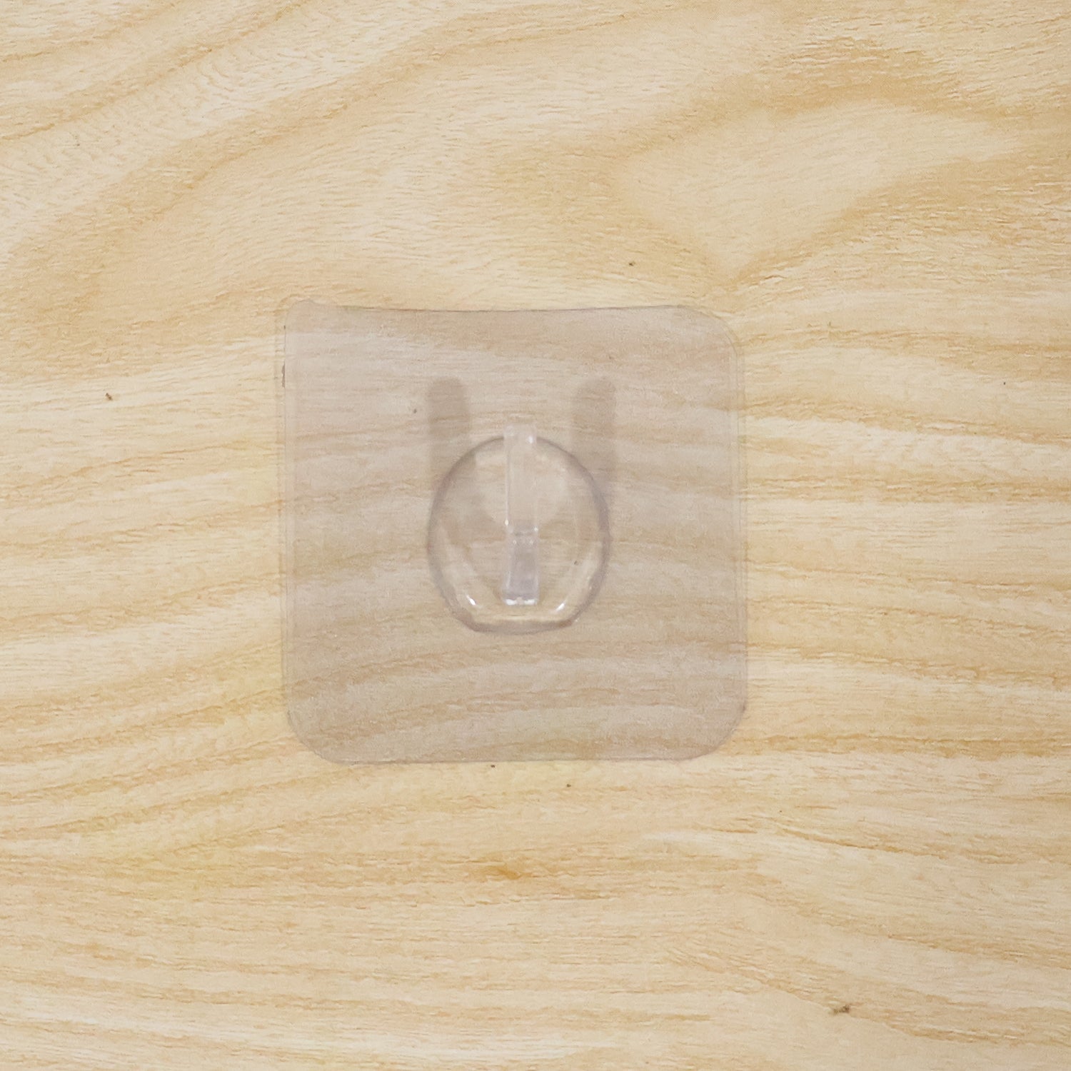 Wall hook on wooden door with transparent adhesive