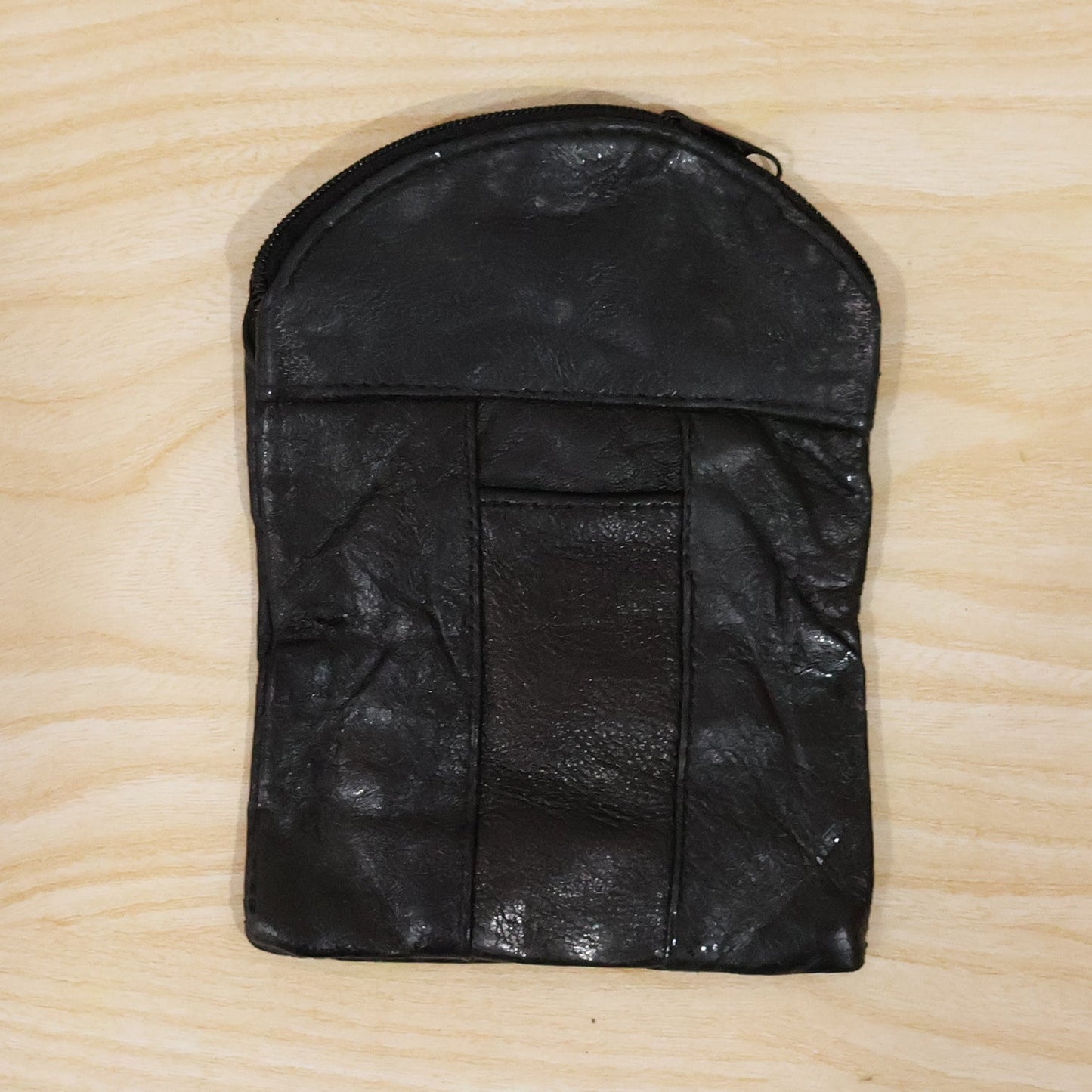 Laying down the black leather mini pouch with its slim profile. Swipeable.