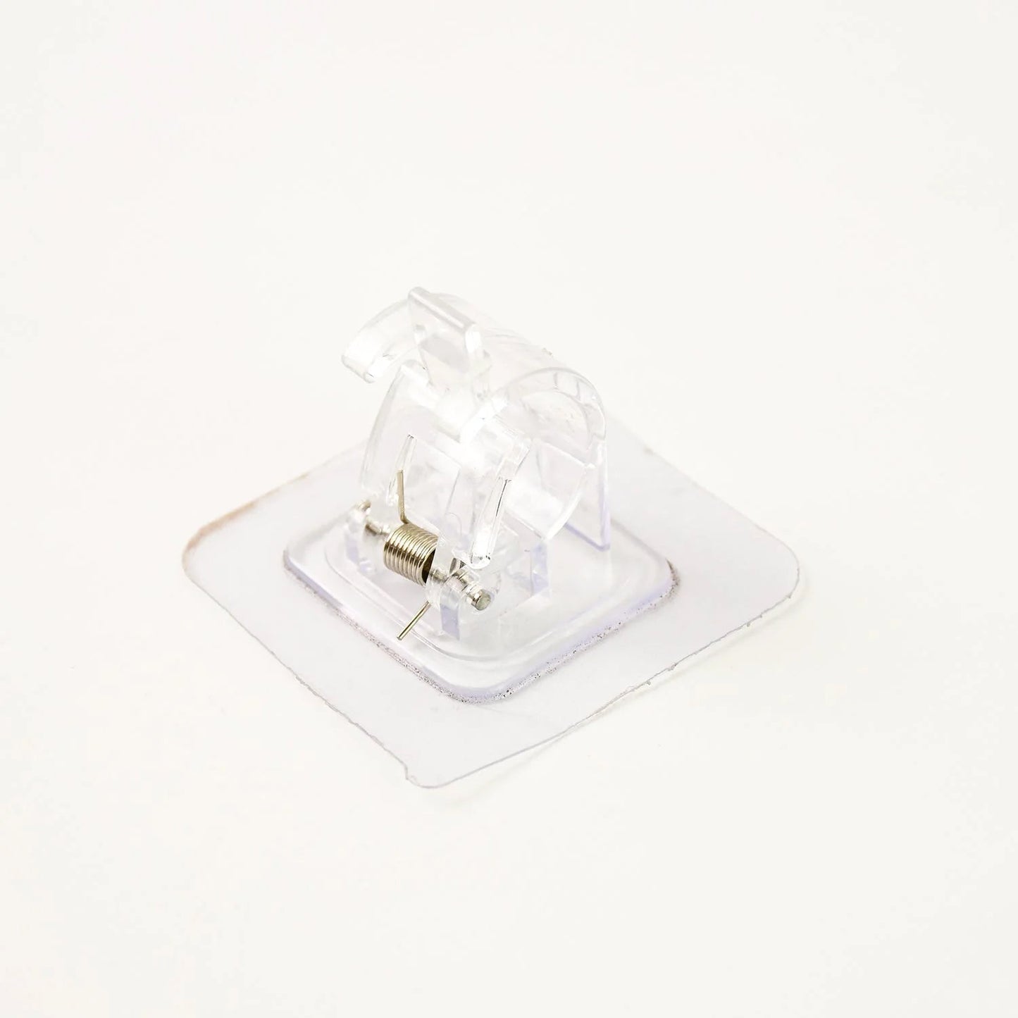 Self-adhesive curtain rail clip installed on wall for lightweight curtains