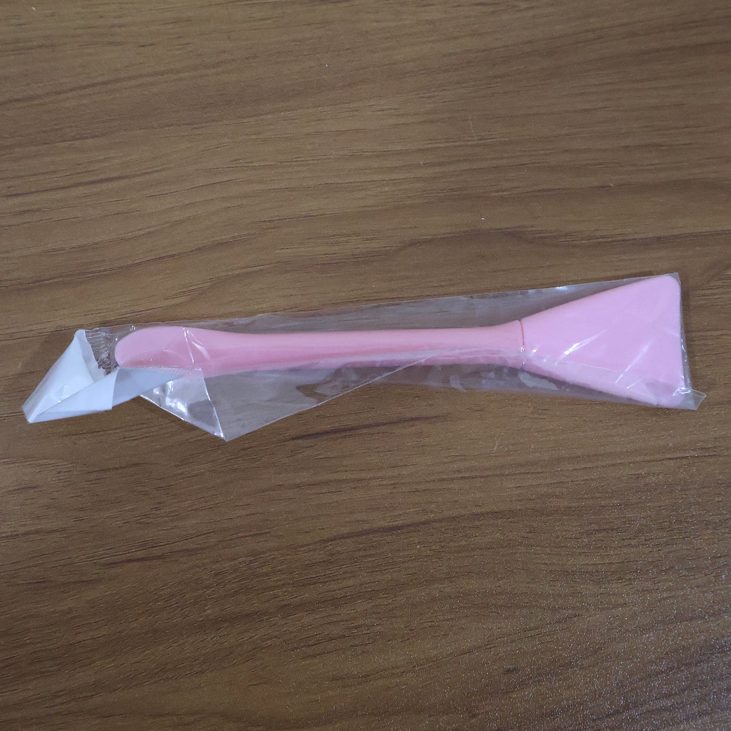 Close-up image of silicone facial mask applicator tool