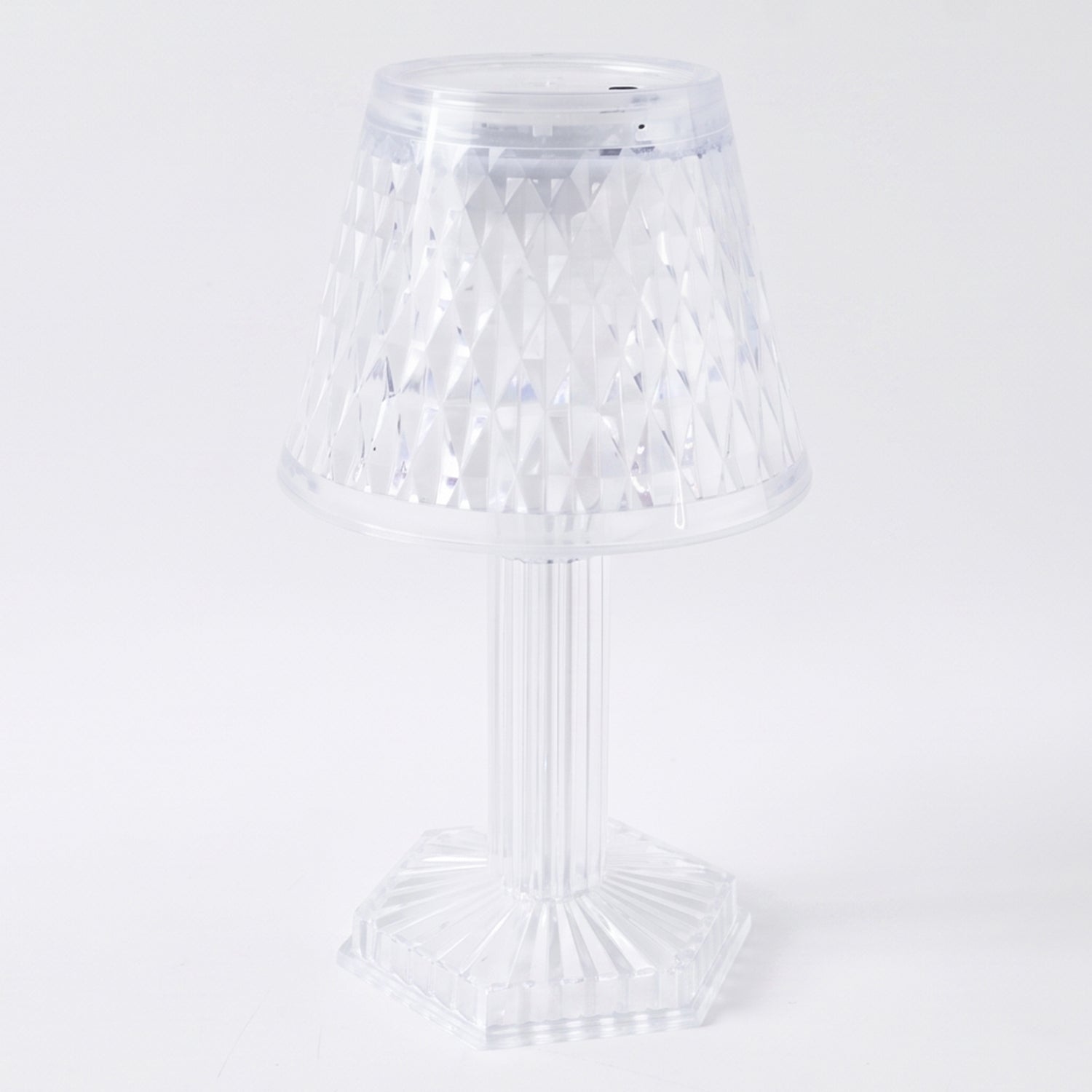 Modern LED crystal lamp displayed on a wooden shelf in a home setting.