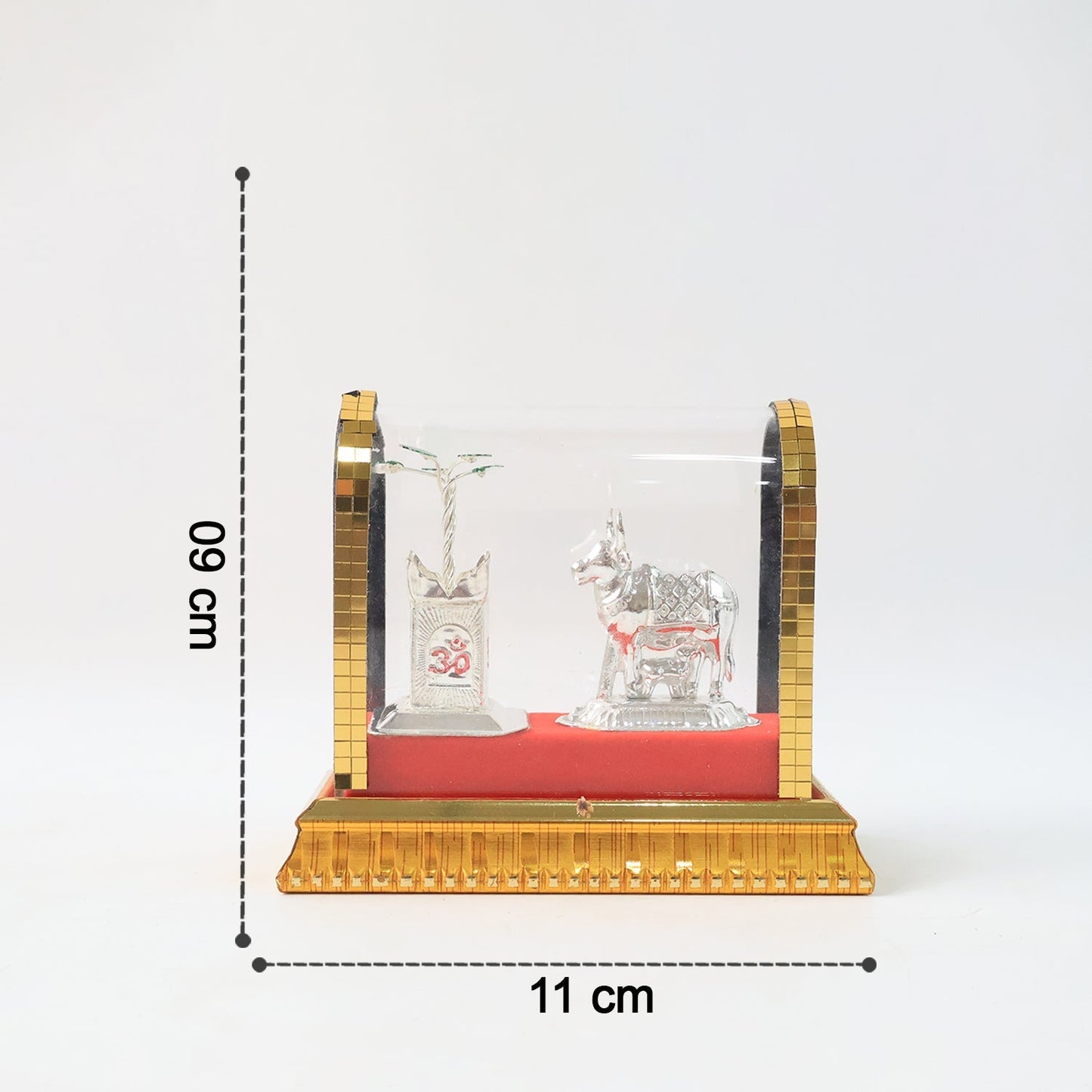 Detailed silver-plated devotional Kamdhenu cow idol with golden display frame